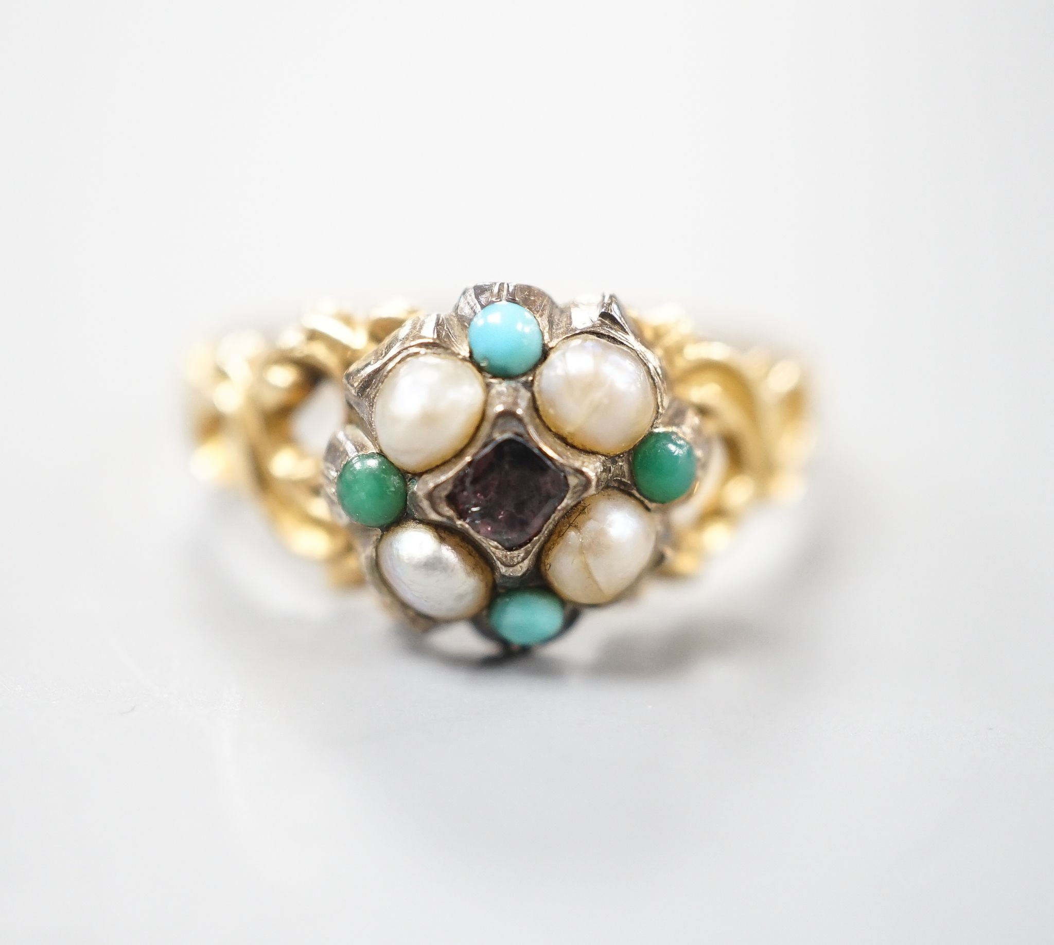 A late Victorian yellow metal, garnet, turquoise and split pearl cluster set dress ring, size M, gross weight 2.9 grams.